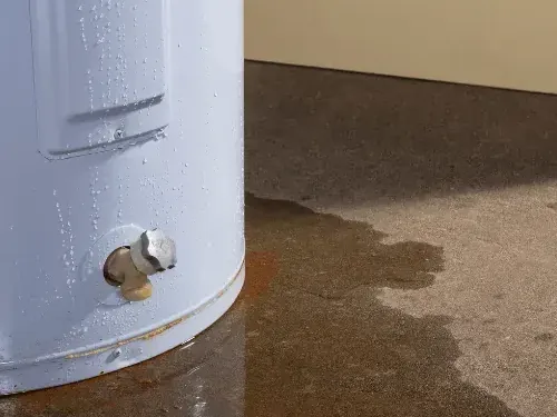 Water spreads across the floor around the base of a tank heater